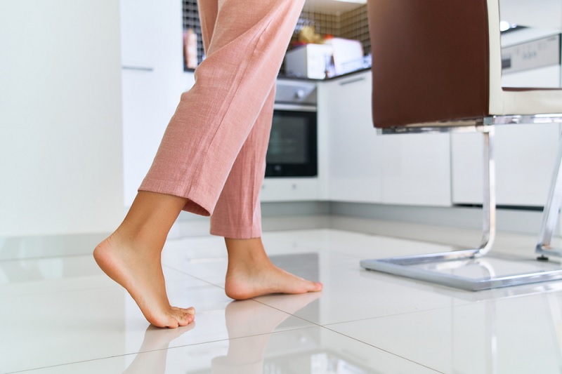 Walking barefoot on tile floor