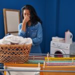 Woman doing laundry smelling clothes
