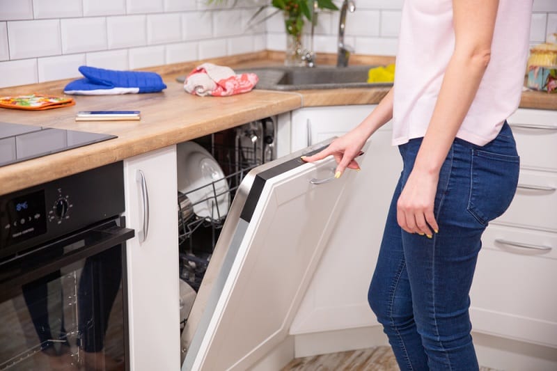 Women opening dishwasher