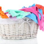 Colourful clothes in laundry basket