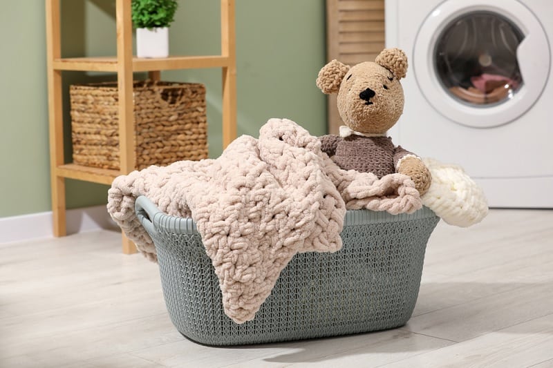 Teddy bear in laundry basket