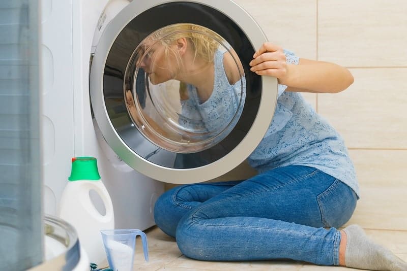 Woman looking into washing machine