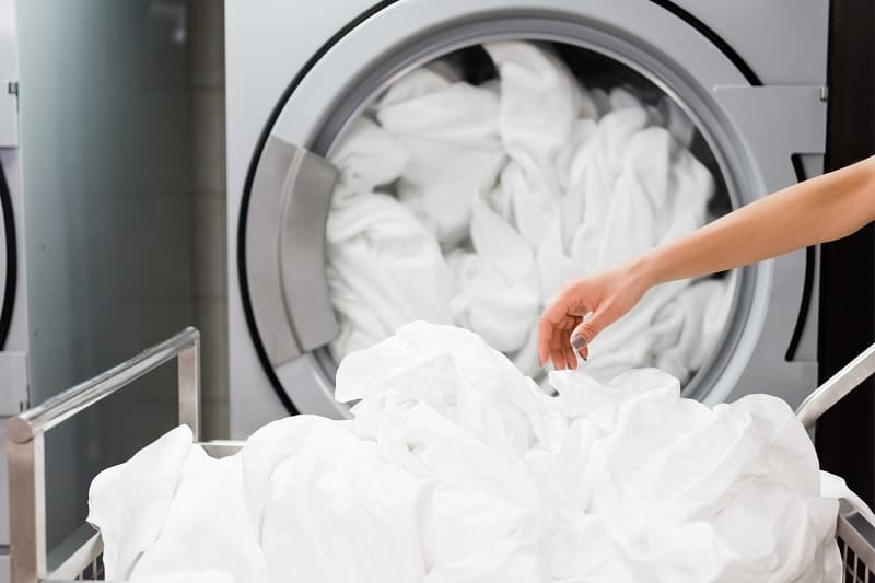 Putting sheets in washing machine