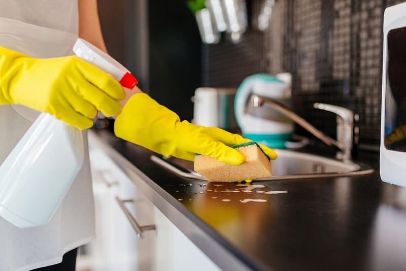 Cleaning Kitchen Surface With Spray Cleaner