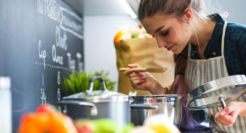 Woman Smelling Aroma From Pan