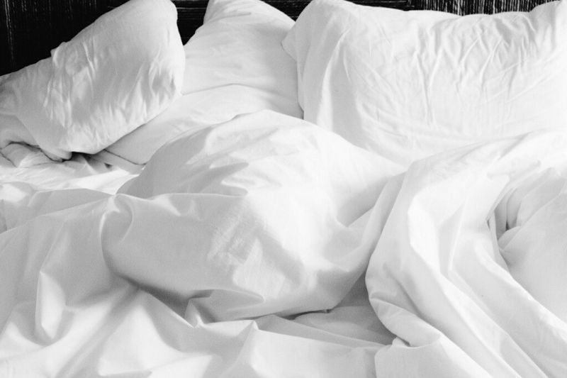 Wrinkled white bedsheets