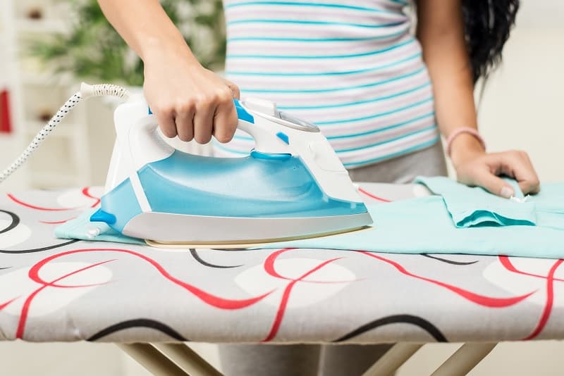 Close up woman ironing