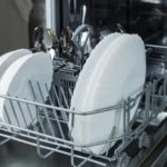 Open dishwasher with plates