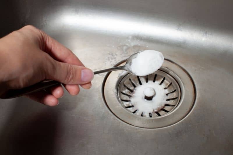 Pouring Baking Soda onto the Sink