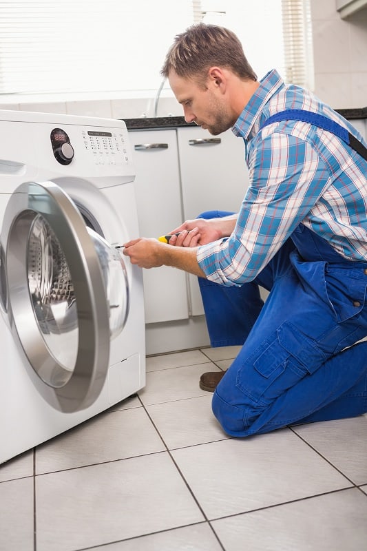 Man fixing washing machine