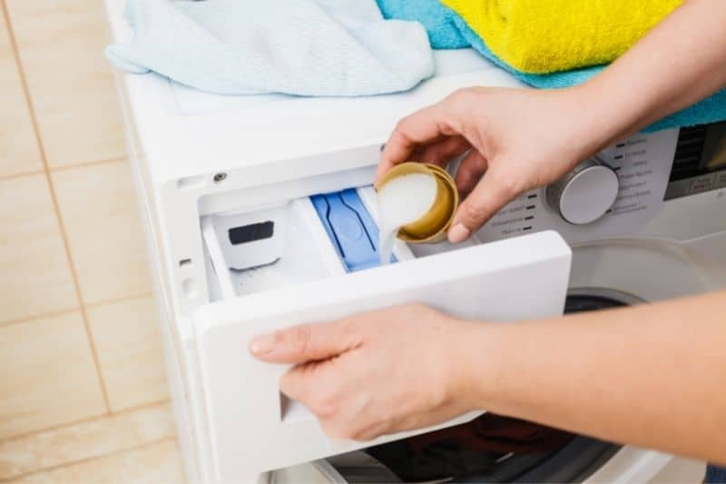 Pouring Liquid Detergent into the Detergent Drawer