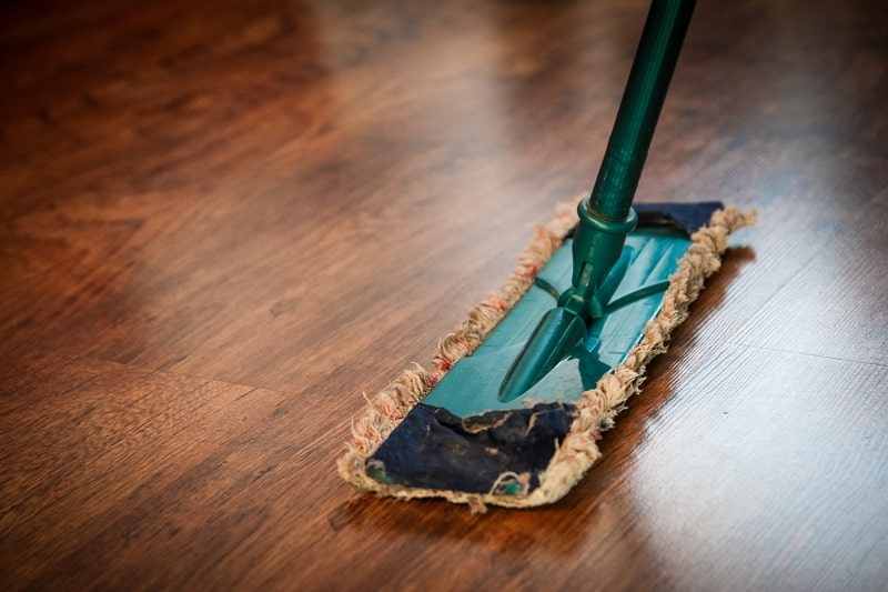 using a mop to clean wet floor