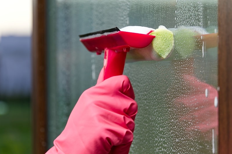 cleaning the window with squeegee