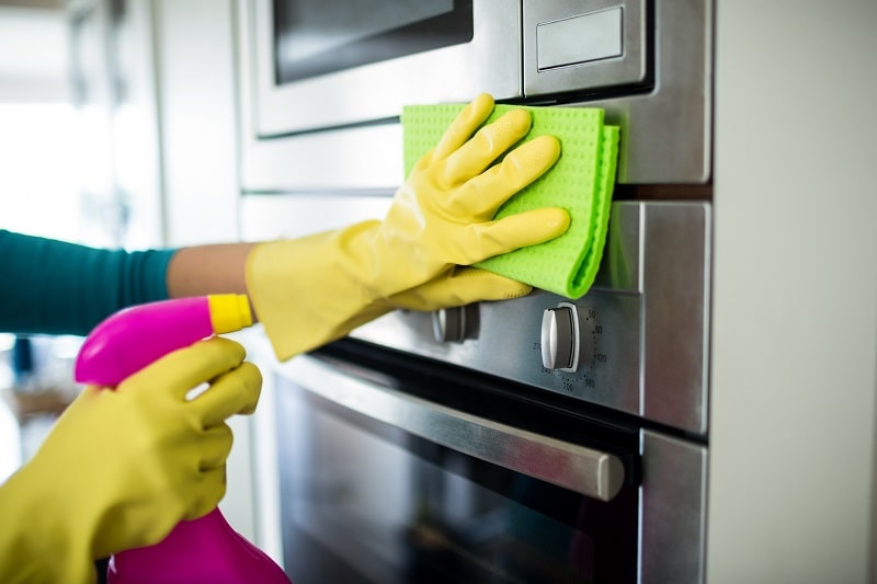 woman cleaning the oven