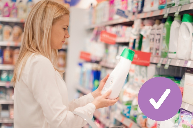 woman checking fabric softener label for ingredients