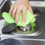 Cleaning gas hob with microfibre cloth