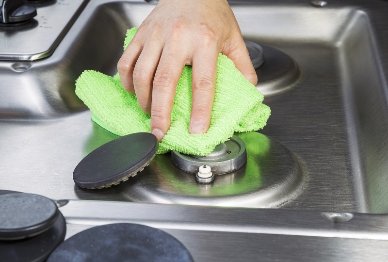 Cleaning gas hob with microfibre cloth