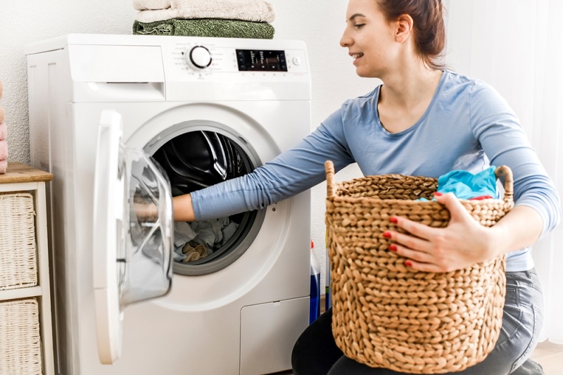 Woman using washing machine