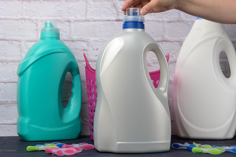 Hand on laundry liquid bottle