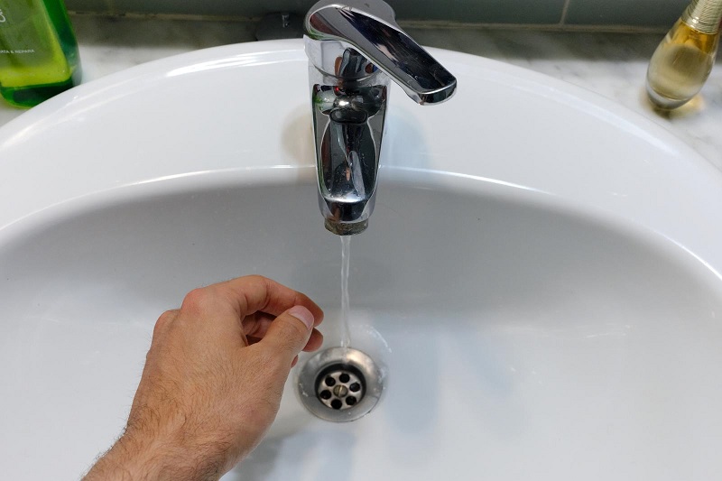 Running tap in bathroom sink