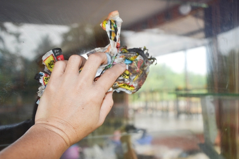 buffing windows with newspaper