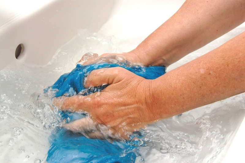 hand-washing clothes in the sink