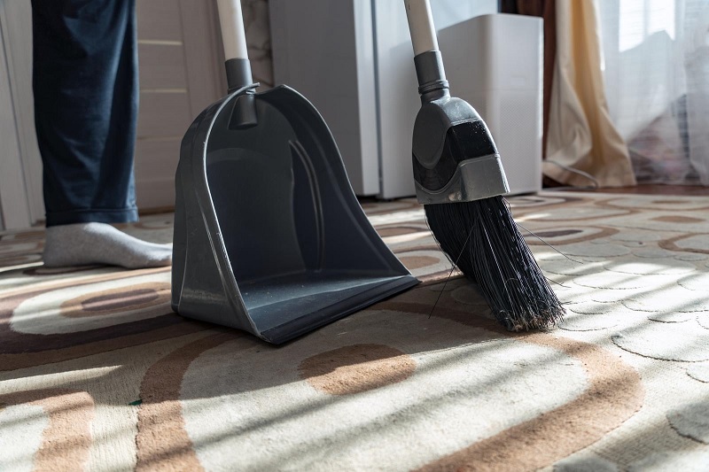 Dustpan and brush on carpet