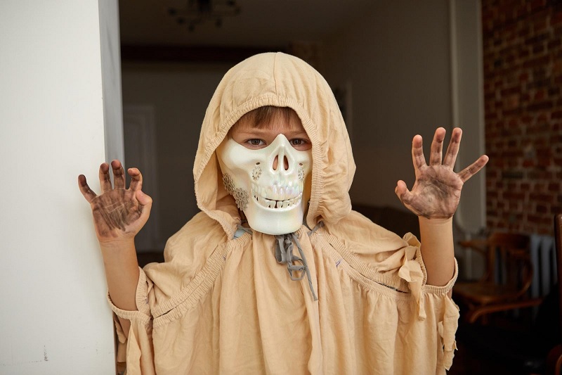 Boy in Halloween costume with mask