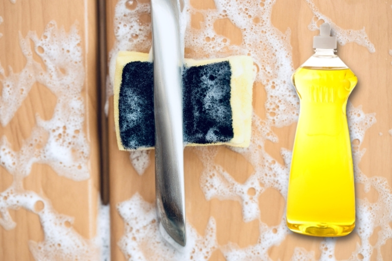 cleaning kitchen cabinet with dishwashing liquid