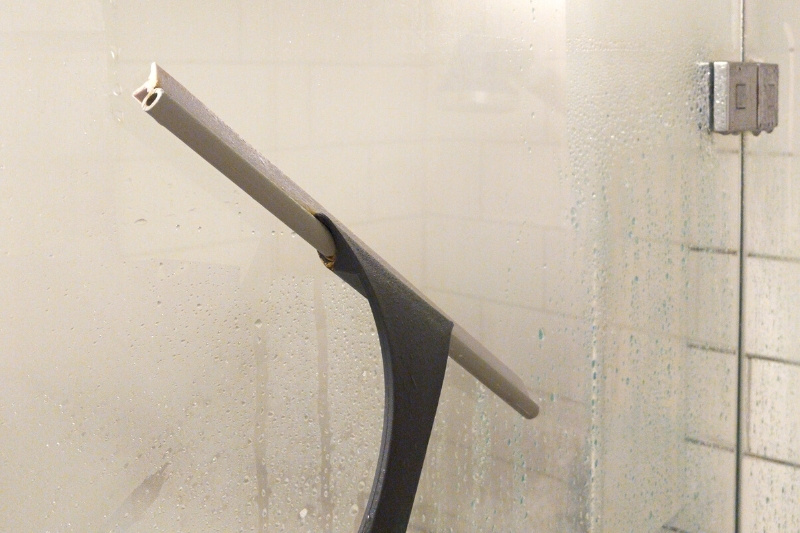 using squeegee on shower door