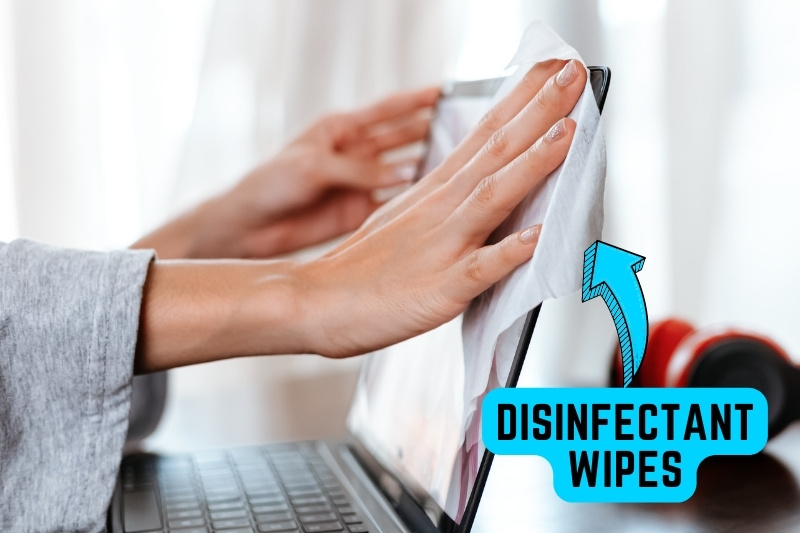 clean laptop screen with disinfectant wipes