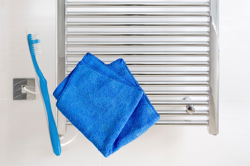 clean towel rail with toothbrush and microfibre cloth