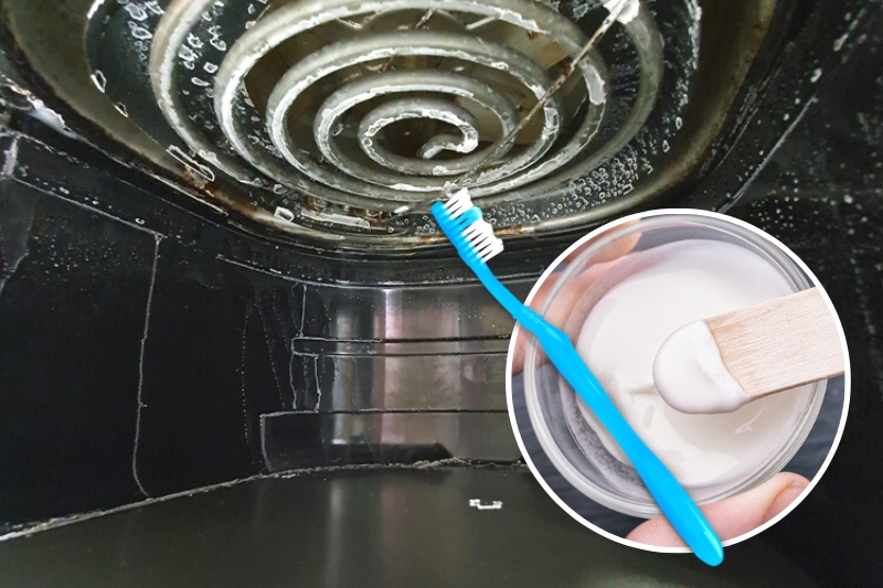 cleaning air fryer with bicarbonate of soda paste and toothbrush