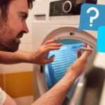 man repairing tumble dryer