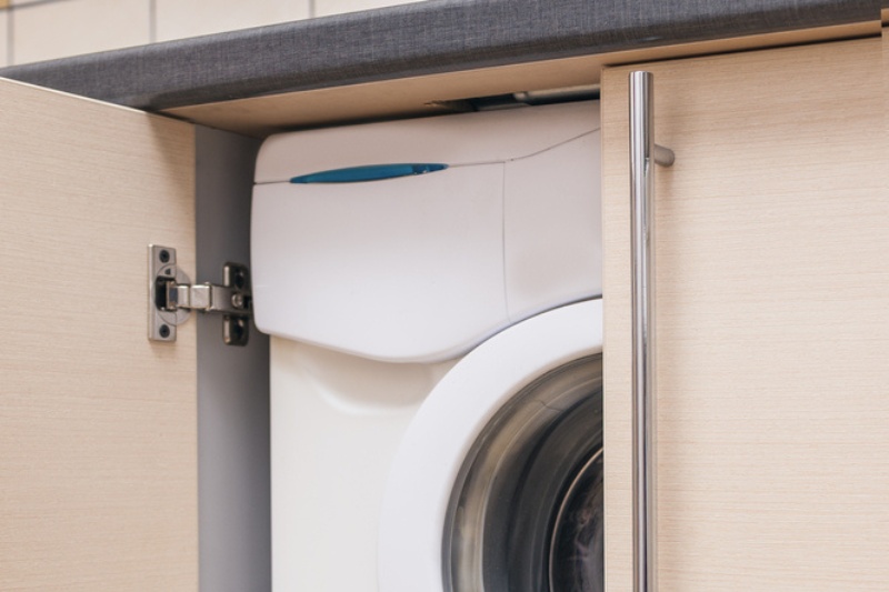 washing machine in cupboard