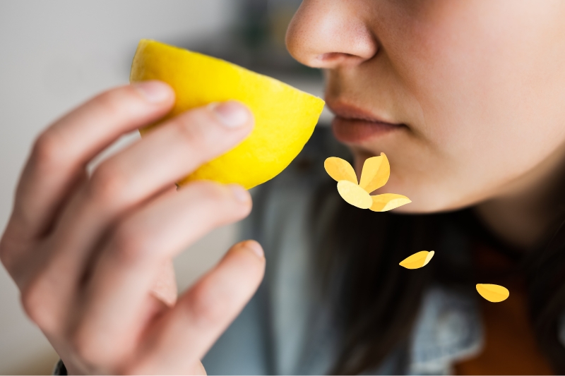 woman smelling lemon