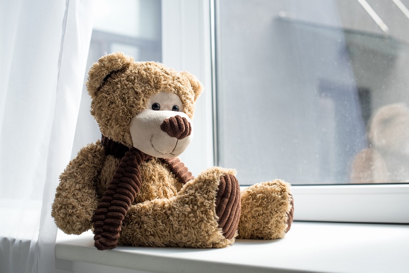 Teddy bear on windowsill