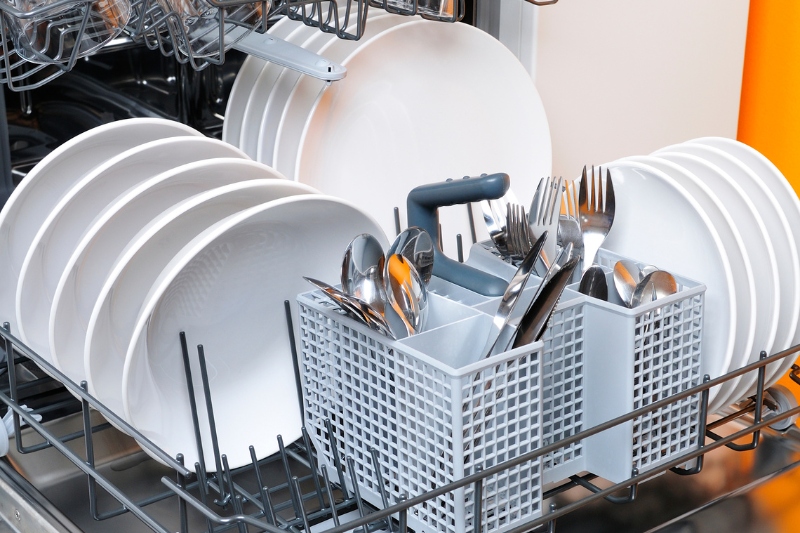 plates and cutlery in the dishwasher