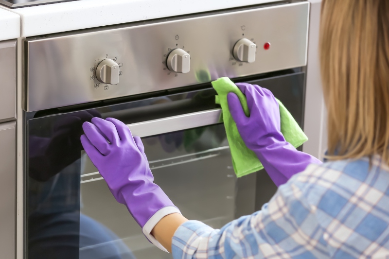 woman cleaning the oven