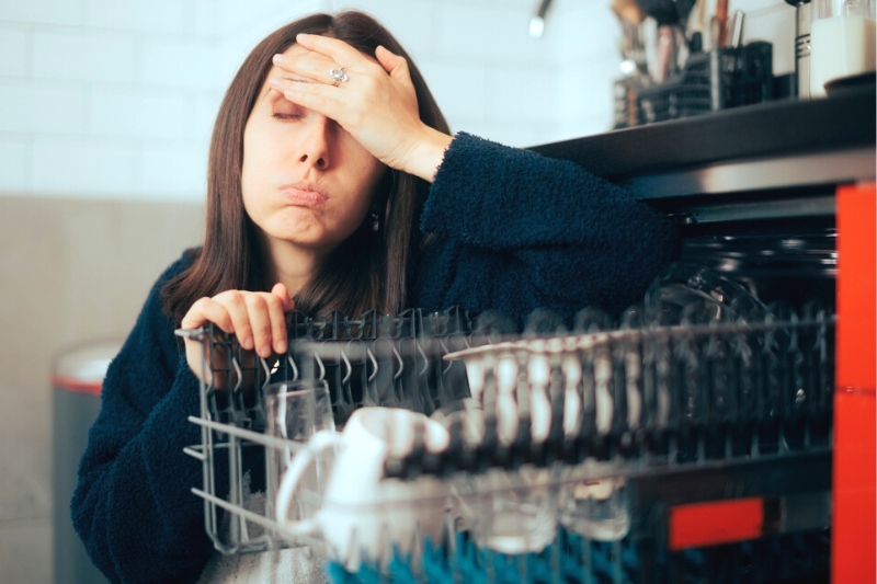 woman frustrated with dishwasher