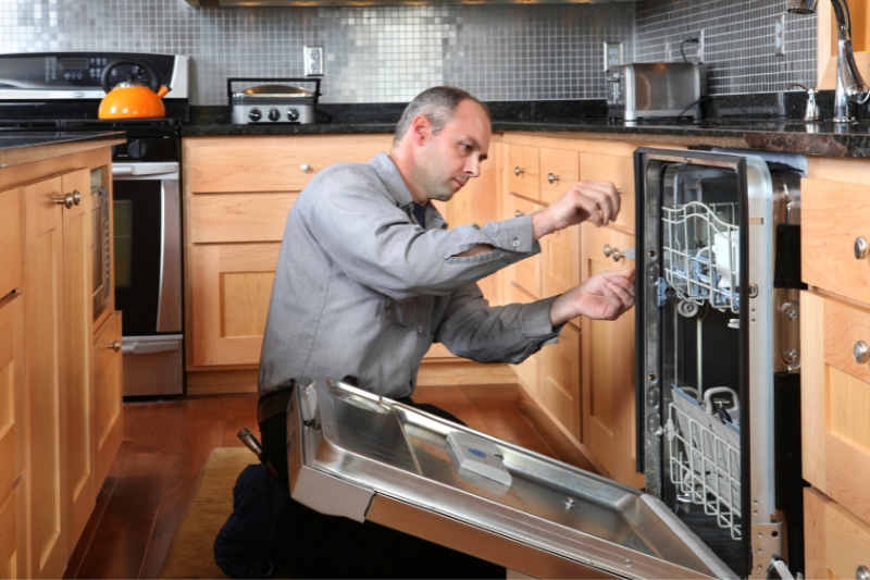 man fixing dishwasher