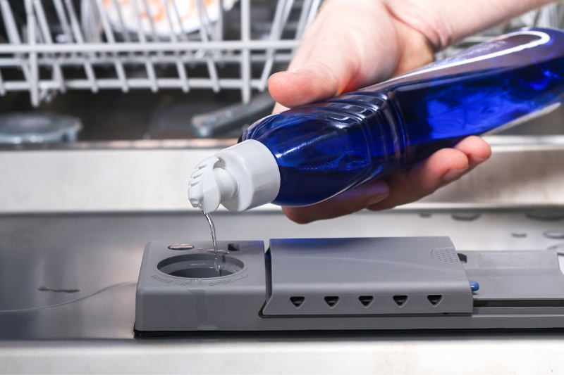 pouring rinse aid on dishwasher