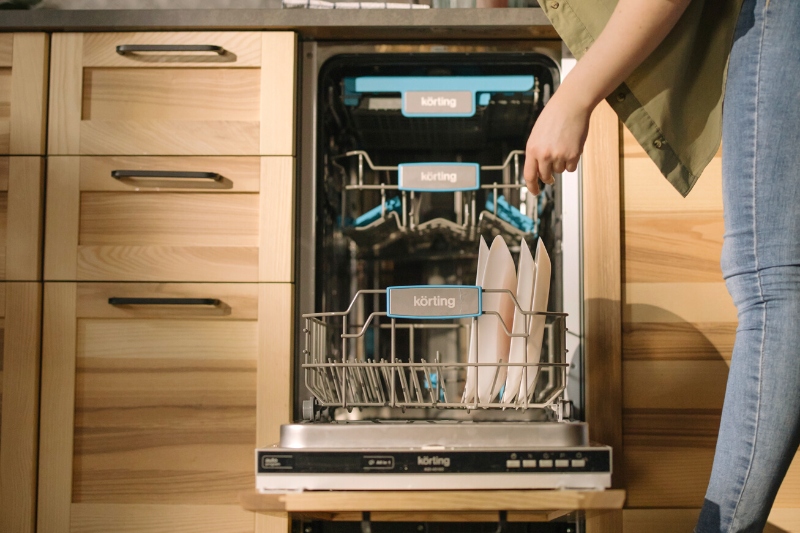 woman putting dishes in the dishwasher