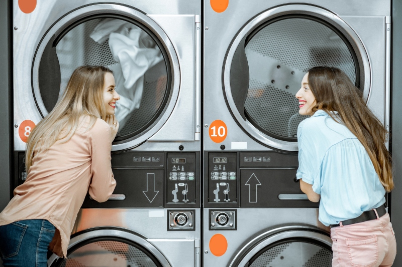 woman using launderette drying machines