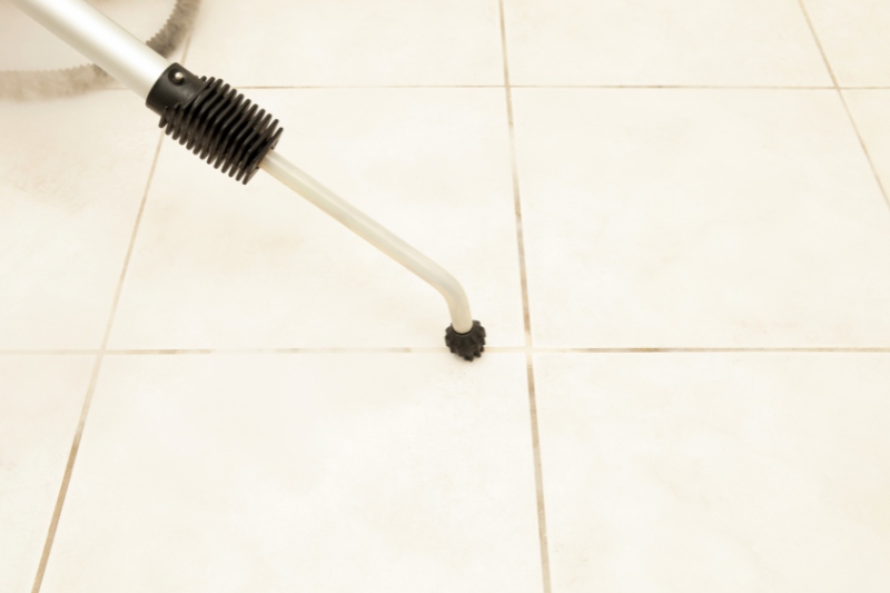 clean bathroom tiles with steam cleaner