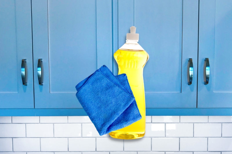 clean painted kitchen cabinet with washing up liquid