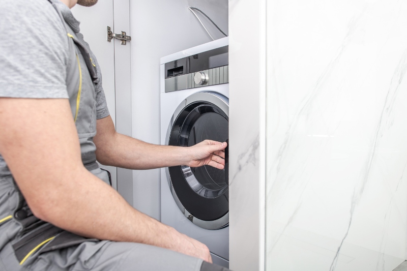 man installing washing machine