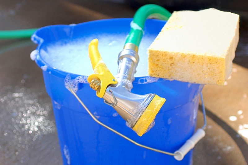 sponge, hose and bucket with soapy water