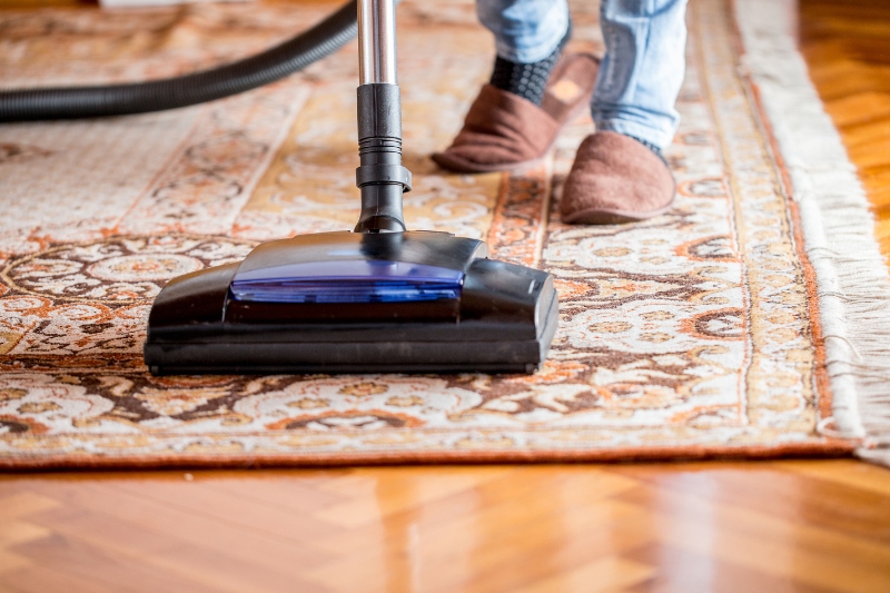 vacuuming floor rug