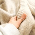 hand holding an alpaca sweater